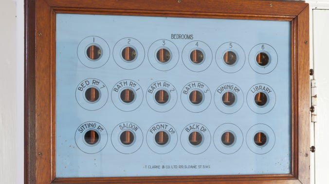 The electric bell board in the Servants' Corridor at Coleton Fishacre, Devon